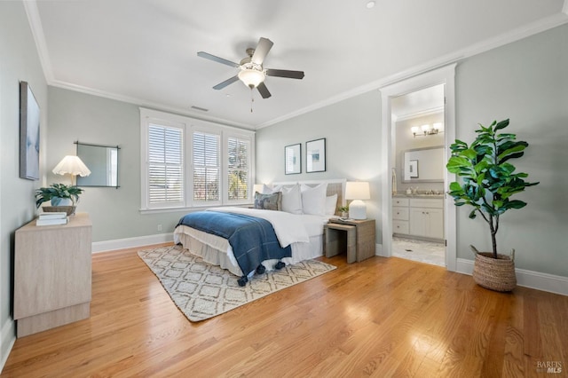 bedroom featuring connected bathroom, crown molding, ceiling fan, and light wood-type flooring