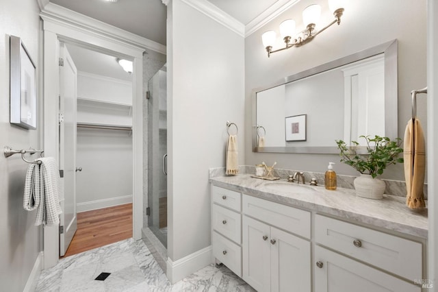 bathroom with vanity, crown molding, and walk in shower