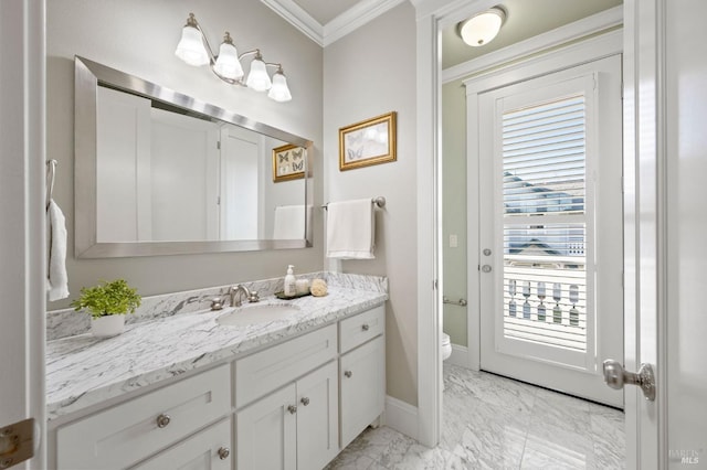 bathroom with vanity, crown molding, and toilet