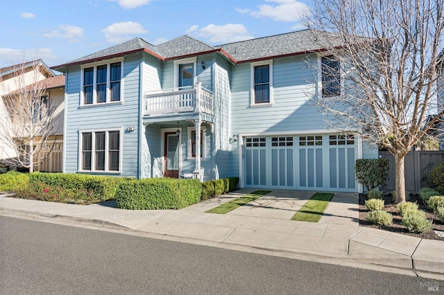 view of front property with a garage and a balcony