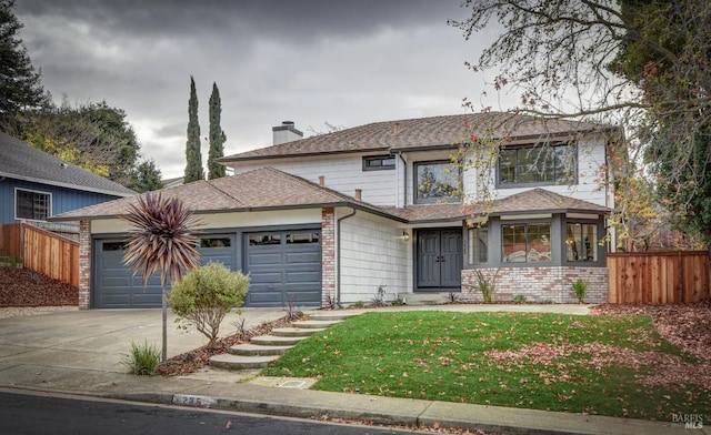 view of front of property with a front lawn and a garage