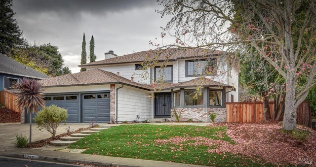 view of property featuring a front yard and a garage