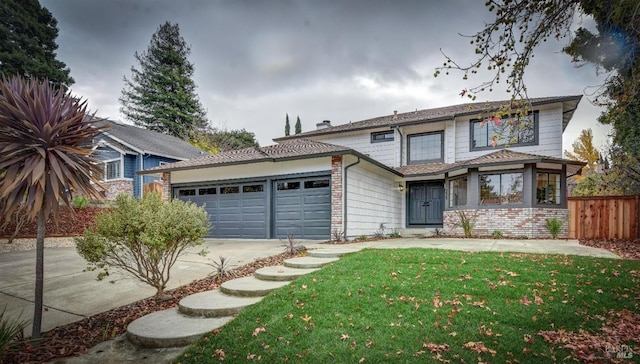 front of property with a front lawn and a garage