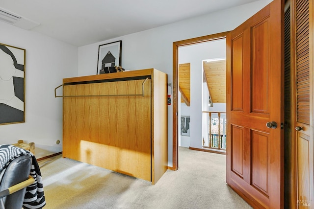 interior space featuring light carpet, visible vents, and baseboards