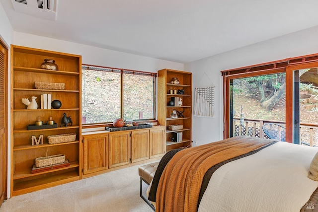 bedroom with light colored carpet, access to outside, and visible vents