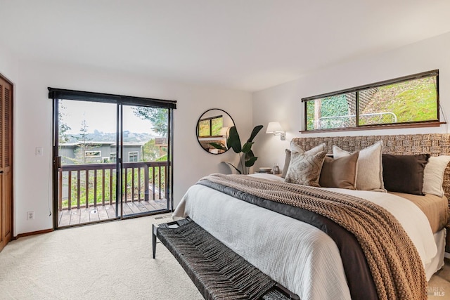 bedroom featuring light colored carpet, baseboards, and access to outside