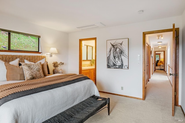 bedroom featuring visible vents, baseboards, connected bathroom, and light colored carpet
