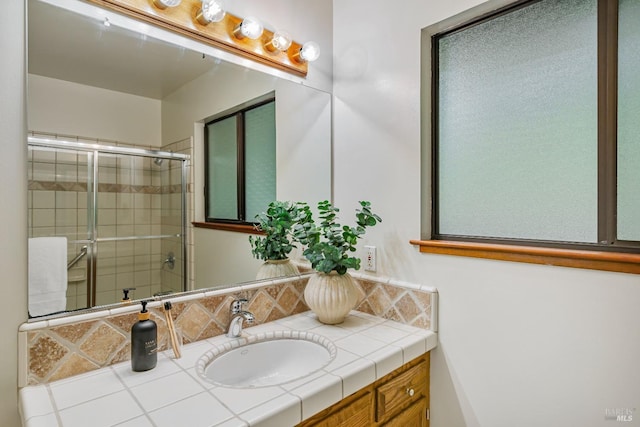 full bathroom featuring vanity and tiled shower