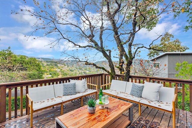 wooden terrace featuring outdoor lounge area