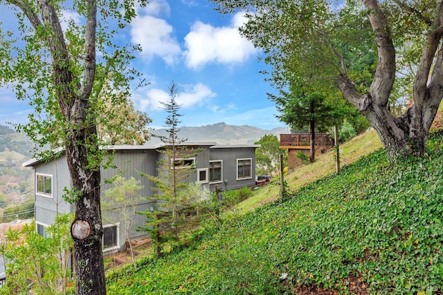 exterior space with a deck with mountain view