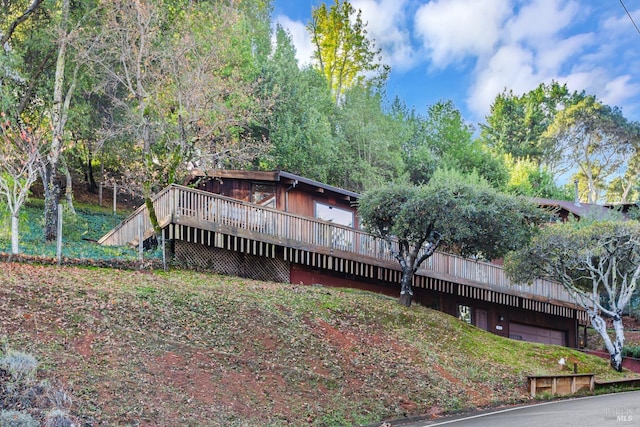 back of house with a wooden deck