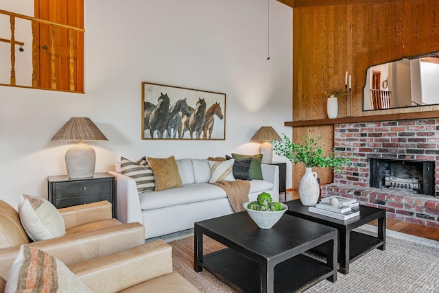 living room with light wood-type flooring and a brick fireplace