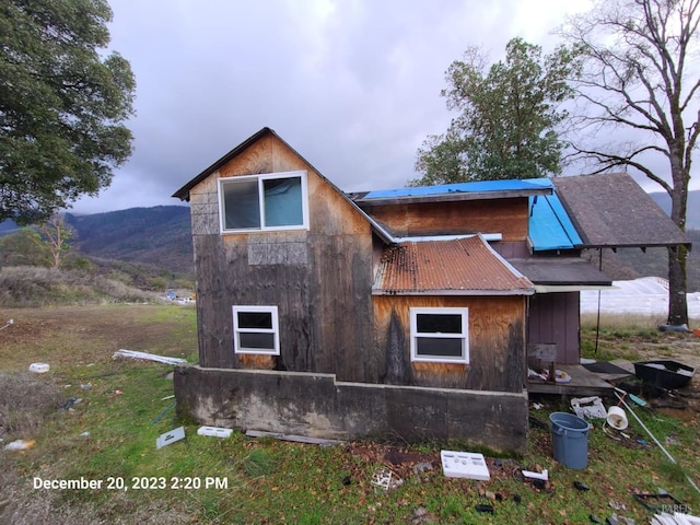 view of side of home with a mountain view