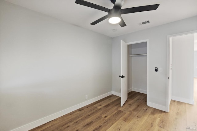 unfurnished bedroom with visible vents, baseboards, ceiling fan, light wood-style flooring, and a closet