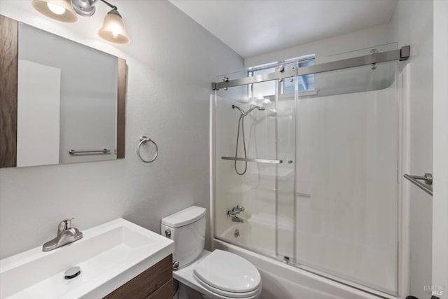 bathroom featuring vanity, toilet, and bath / shower combo with glass door