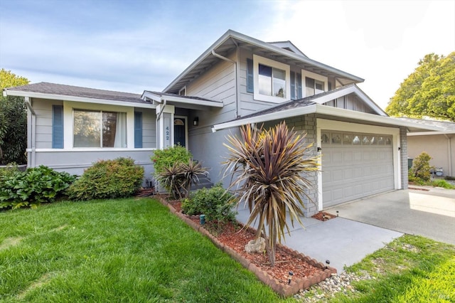tri-level home featuring concrete driveway, an attached garage, a front yard, and stone siding