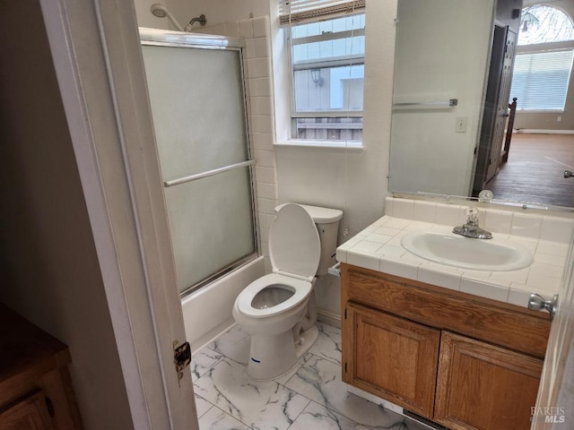 full bathroom with vanity, combined bath / shower with glass door, and toilet