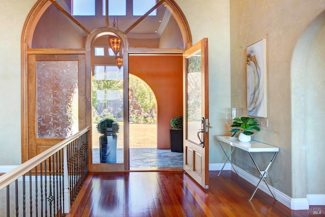 foyer entrance featuring baseboards and wood finished floors