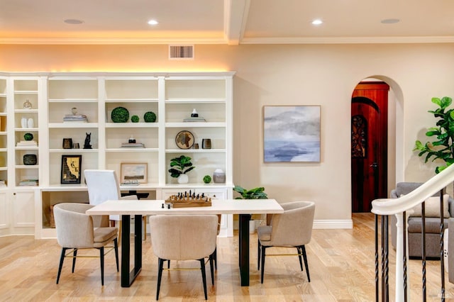 dining area with arched walkways, visible vents, crown molding, and light wood-style flooring