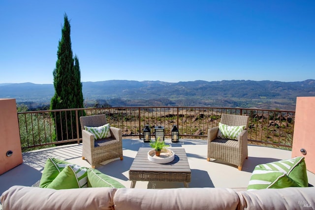 view of patio featuring a mountain view and an outdoor living space