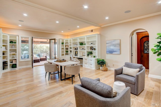 living area with arched walkways, crown molding, baseboards, and light wood-style floors