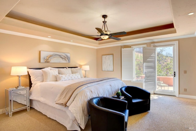 bedroom featuring baseboards, access to exterior, a tray ceiling, carpet, and crown molding