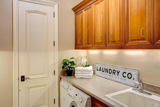 laundry room with cabinet space, a sink, and washer / dryer