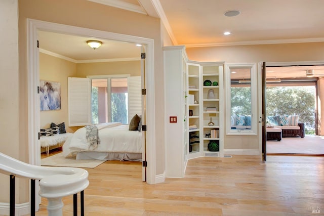 bedroom with multiple windows, light wood-type flooring, and access to exterior