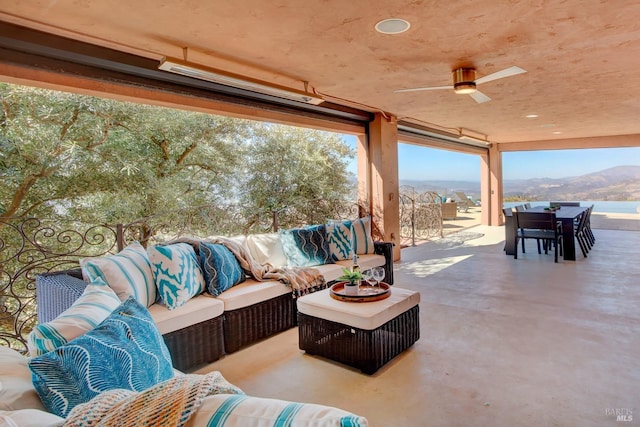 view of patio / terrace with outdoor dining space, outdoor lounge area, a mountain view, and ceiling fan