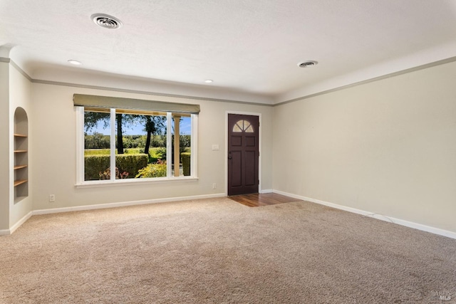 interior space with carpet and crown molding