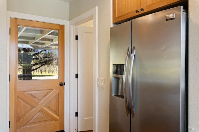 kitchen featuring stainless steel fridge with ice dispenser