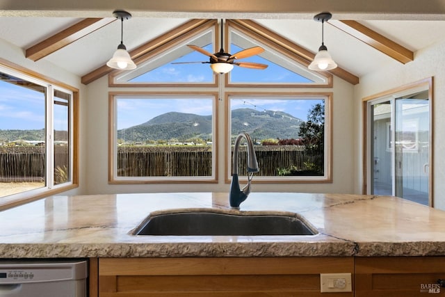 kitchen with vaulted ceiling with beams, a mountain view, sink, and dishwashing machine