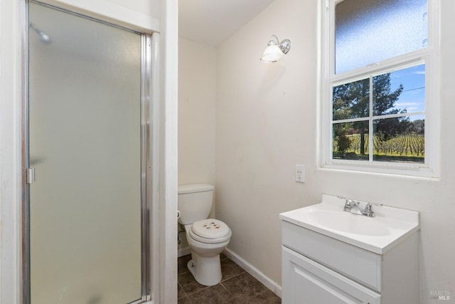 bathroom featuring tile patterned floors, vanity, toilet, and a shower with shower door