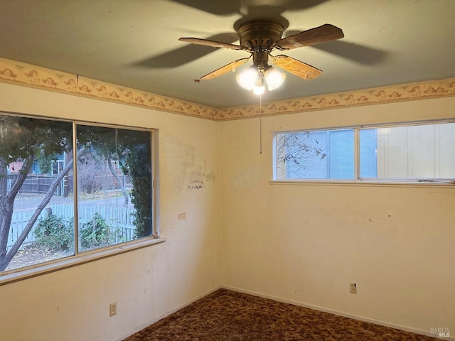 carpeted empty room featuring ceiling fan