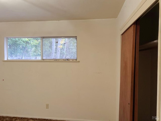 unfurnished bedroom featuring carpet flooring and a closet