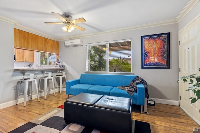 living room with crown molding, a wall mounted air conditioner, ceiling fan, and light wood-type flooring