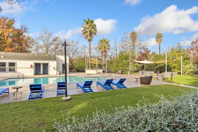 view of swimming pool featuring a patio area and a lawn