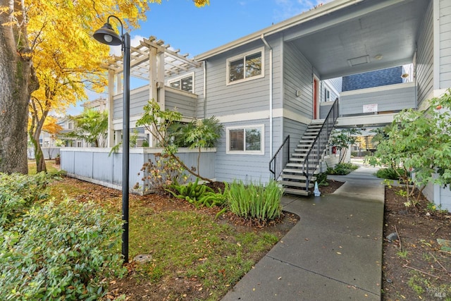 view of side of property featuring a pergola