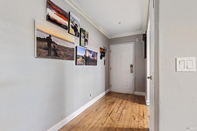 hall with ornamental molding and wood-type flooring