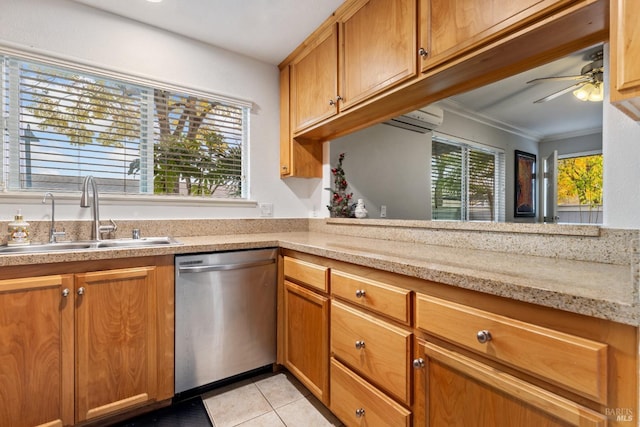 kitchen featuring dishwasher, sink, ornamental molding, light tile patterned floors, and light stone countertops