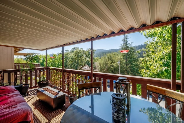 wooden deck with an outdoor fire pit