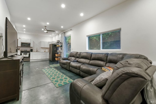 living room featuring ceiling fan, finished concrete floors, and recessed lighting