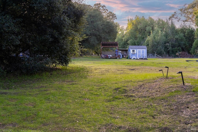 yard at dusk with a storage unit