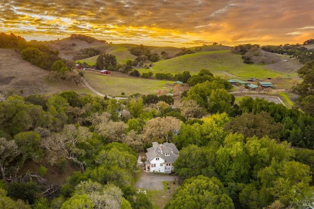 aerial view at dusk featuring a mountain view