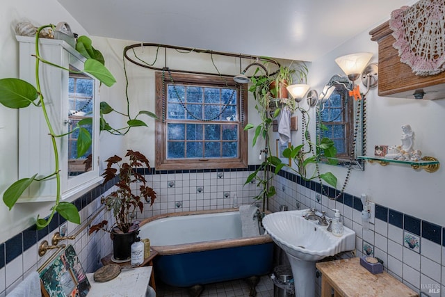 bathroom featuring tile walls, tile patterned flooring, and a tub