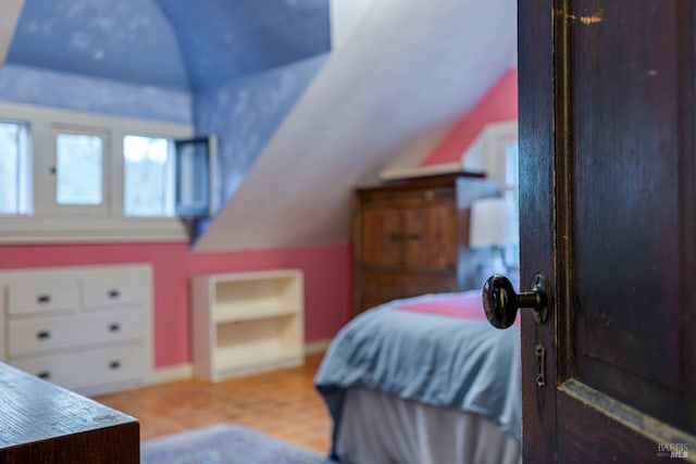 bedroom with lofted ceiling