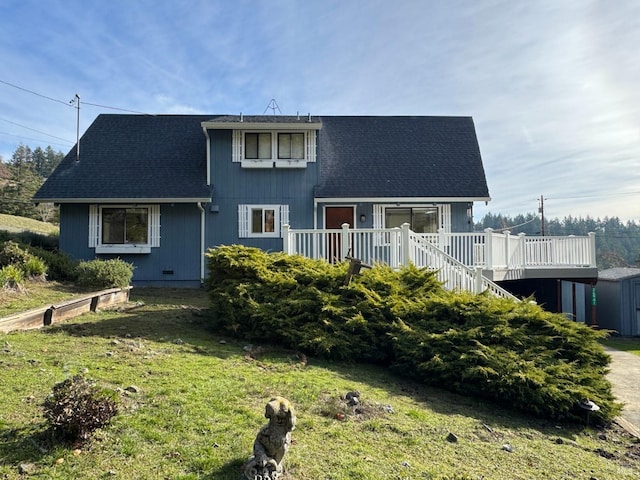 view of front of home with a front yard and a deck