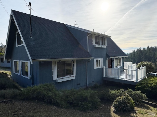 rear view of property featuring a deck