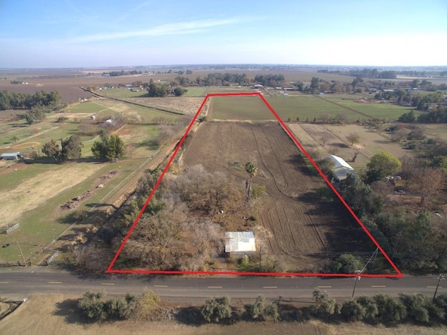 birds eye view of property with a rural view