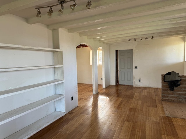 interior space with hardwood / wood-style flooring and beamed ceiling